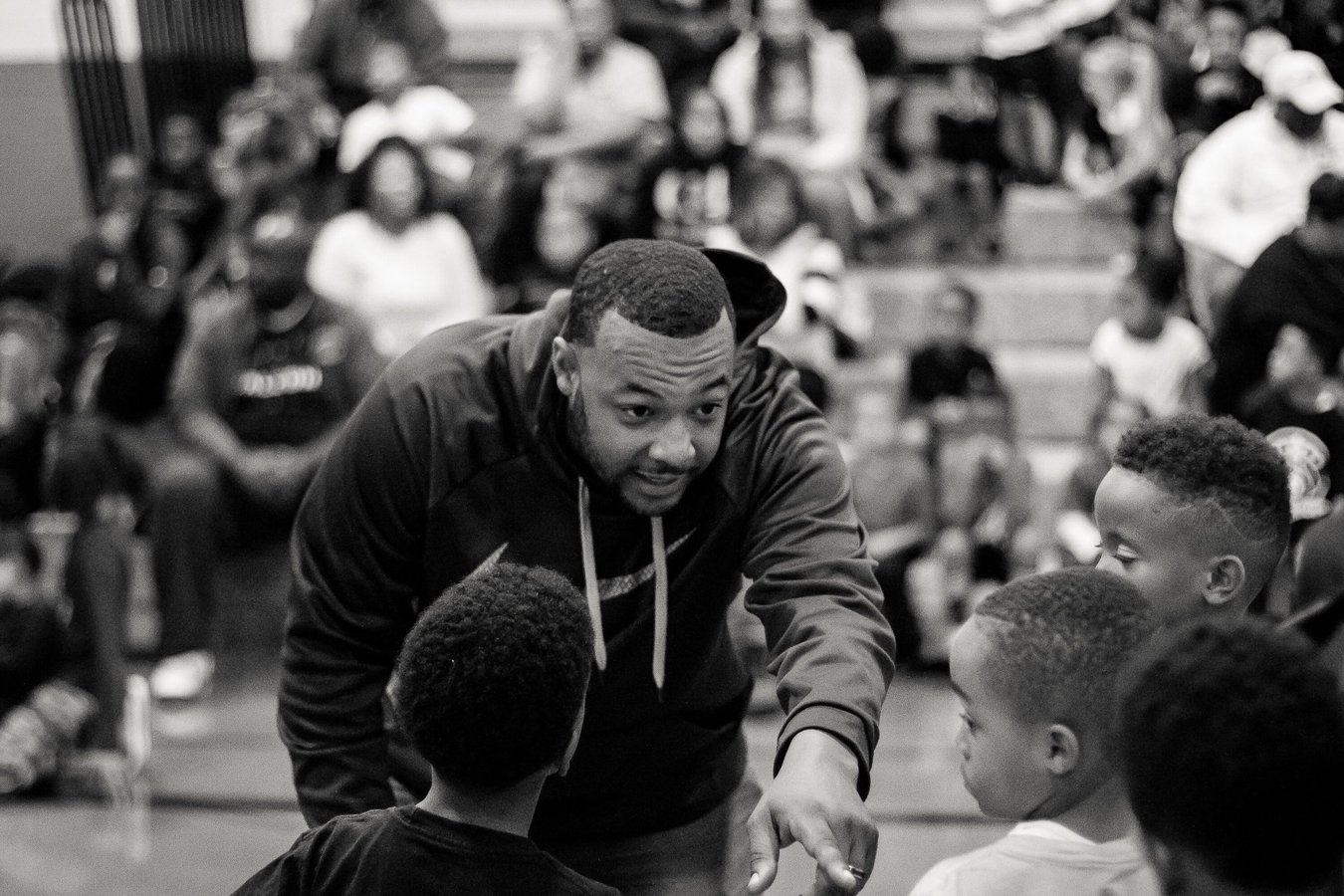 Youth basketball coach encouraging players during a game